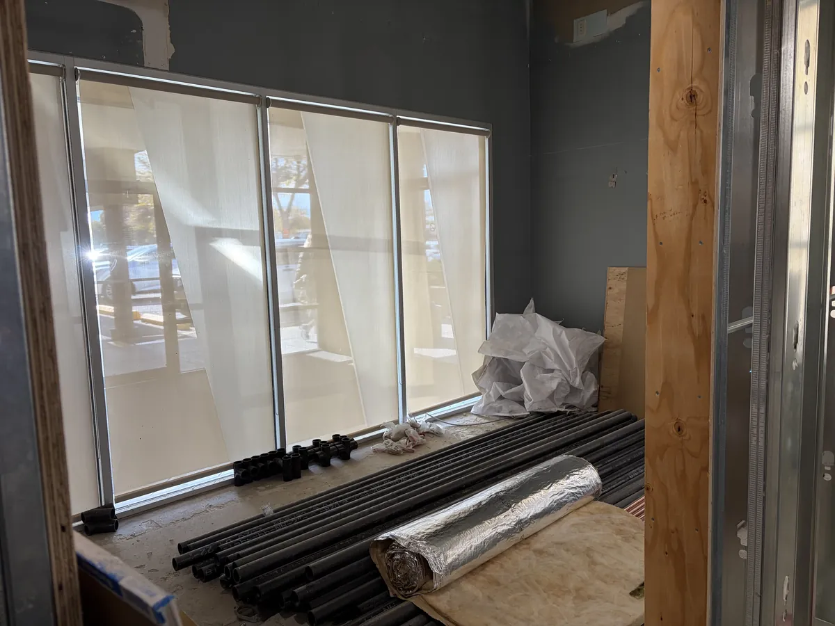 Construction at Bloom Kelowna: inside a steel-framed studio along the exterior windows